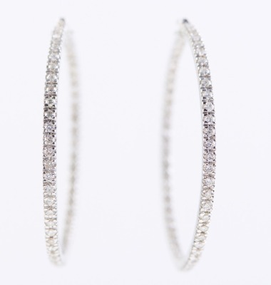 A PAIR OF DIAMOND HOOP EARRINGS