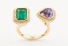 AN OPEN FACE EMERALD AND TANZANITE RING