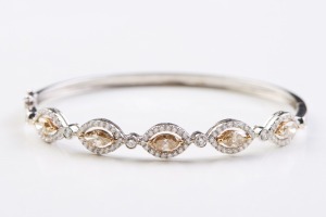 A COLOURED DIAMOND BANGLE