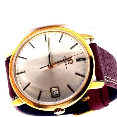 AN OMEGA GOLD WRISTWATCH