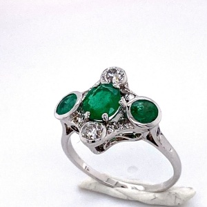 A THREE STONE EMERALD AND DIAMOND RING