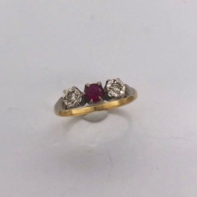 AN ANTIQUE THREE STONE RUBY AND DIAMOND RING