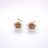 A PAIR OF CERAMIC AND DIAMOND STUDS