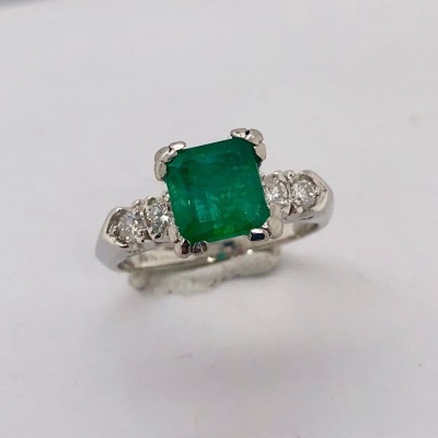 AN EMERALD AND DIAMOND RING