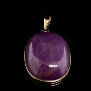 A SYNTHETIC RUBY PENDANT IN GOLD