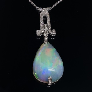 AN ART DECO STYLE TEARDROP OPAL AND DIAMOND PENDANT