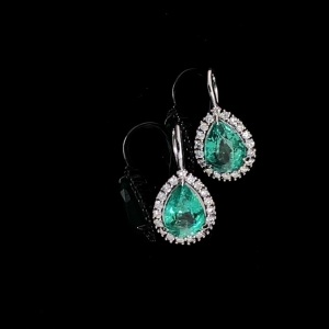 A PAIR OF EMERALD AND DIAMOND CLUSTER EARRINGS