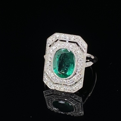 AN ART DECO STYLE EMERALD AND DIAMOND RING