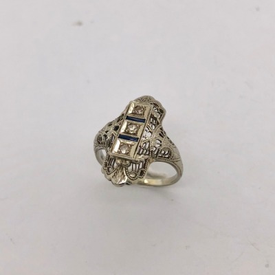 A MID CENTURY DIAMOND AND SAPPHIRE RING