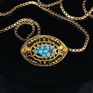 AN ANTIQUE TURQUOISE BROOCH/PENDANT ON GOLD CHAIN