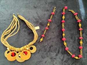TWO COSTUME NECKLACES ONE WITH CONFORMING BRACELET