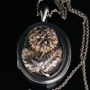 AN ANTIQUE SCOTTISH SILVER LOCKET AND CHAIN