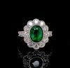 AN EMERALD AND DIAMOND CLUSTER RING