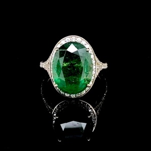 AN EMERALD AND DIAMOND CLUSTER RING