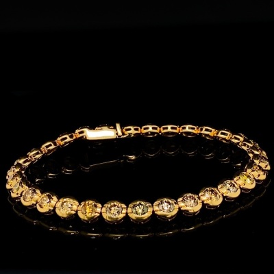 A FANCY COLOURED DIAMOND LINE BRACELET