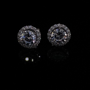 A PAIR OF CZ AND DIAMOND STUDS