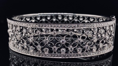 A GOLD AND DIAMOND HINGED BANGLE