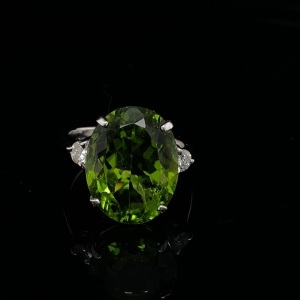 A PERIDOT AND DIAMOND RING