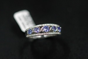 A FIVE STONE TANZANITE AND DIAMOND RING