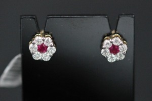 A PAIR OF RUBY AND DIAMOND STUDS