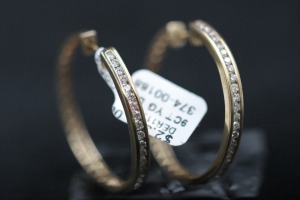 A PAIR OF DIAMOND HOOP EARRINGS