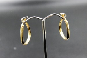 A PAIR OF GOLD HOOP EARRINGS