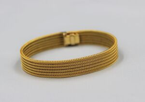 (ADDED TO NECKLACE) A RETRO GOLD BRACELET BY SCHOFER