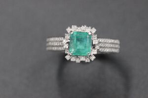 AN EMERALD AND DIAMOND RING