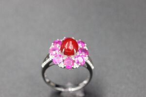 A CORAL, PINK SAPPHIRE AND DIAMOND RING