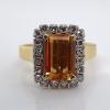 AN IMPERIAL TOPAZ AND DIAMOND RING