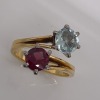 A GEM SET CROSSOVER RING - 4