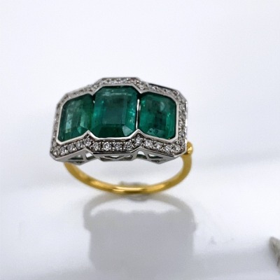 AN EMERALD AND DIAMOND RING