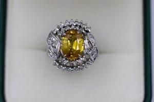 A VINTAGE YELLOW SAPPHIRE AND DIAMOND RING.