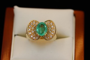 AN EMERALD AND DIAMOND DRESS RING