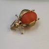 A CORAL BEETLE BROOCH