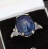 A LARGE CABOCHON SAPPHIRE AND DIAMOND RING