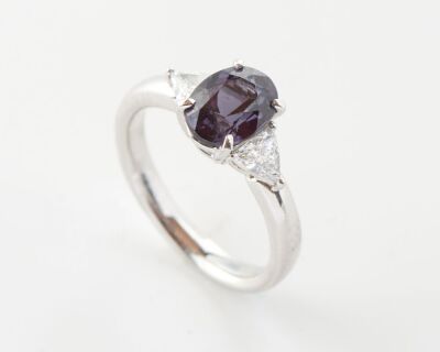 A COLOUR CHANGE GARNET AND DIAMOND RING